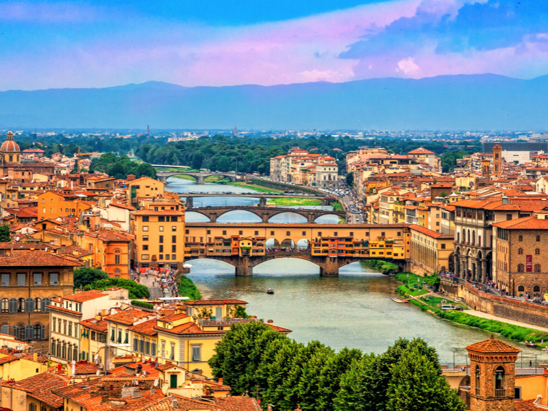 Aerial view of medieval stone bridge Ponte Vecchio over Arno river in Florence, Tuscany, Italy. Florence cityscape. Florence architecture and landmark.