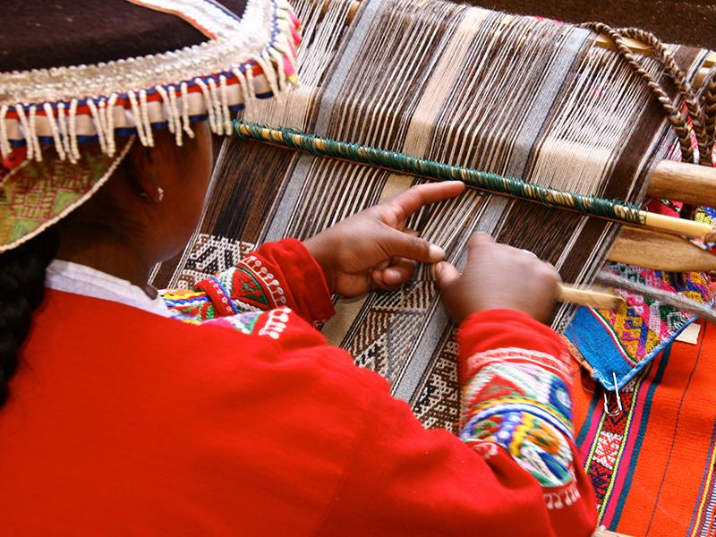 Un tren de pasajeros avanzando por los paisajes del Valle de los Andes en Perú