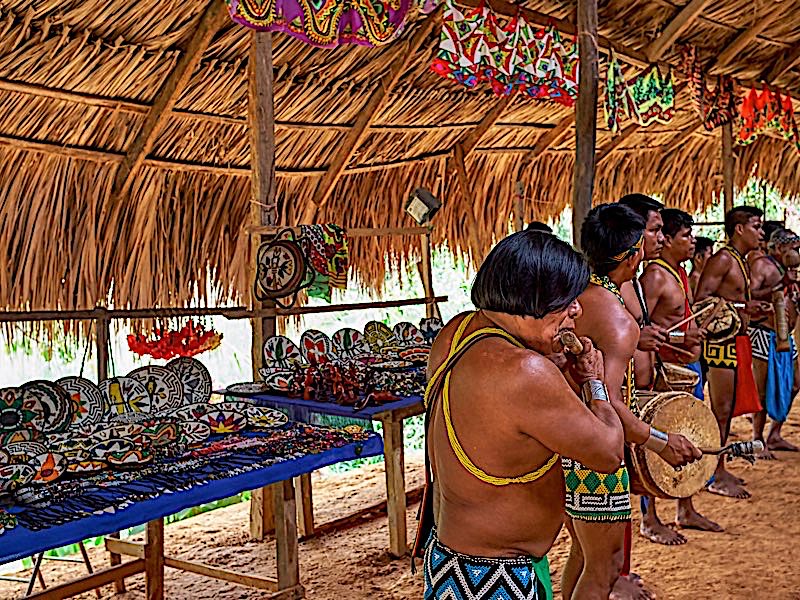 Chagres National Park, Panama - April 22, 2018: Embera native people playing authentic music, dressed with traditional clothing and jewelries. Embera indigenous people live today as many decades ago.