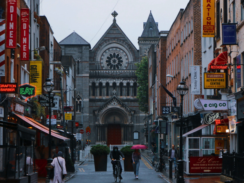 Dublin, Ireland - September 15th, 2019: On a rainy day in Dublin, a view of St. Ann's Church of Ireland from Grafton Street reveals the church's elegant architecture through a soft drizzle.