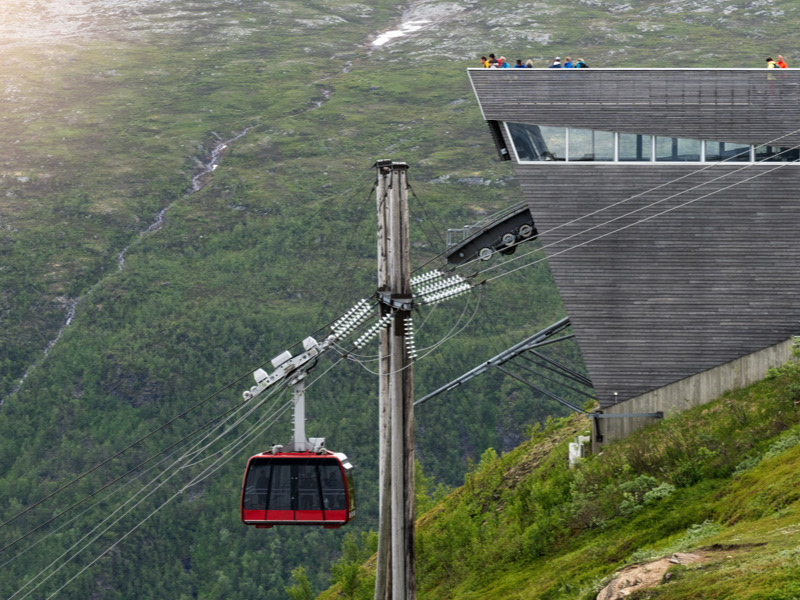 Tromso, Norway - June 21, 2024: Tourists looking at the view over Tromso from the top of Storsteinen mountain.